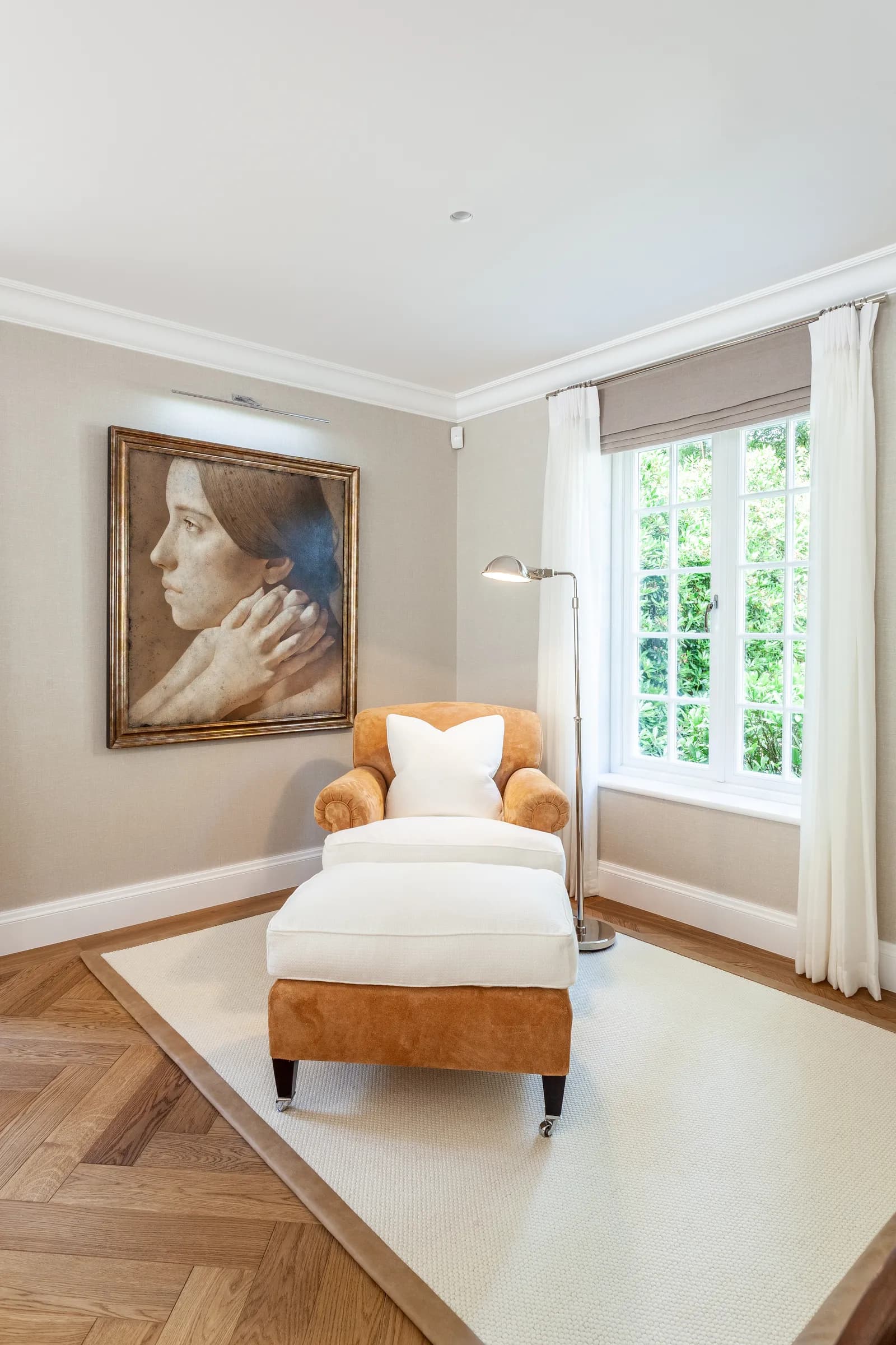 Period interior with herringbone floor, leather chaise longue and classical oil painting