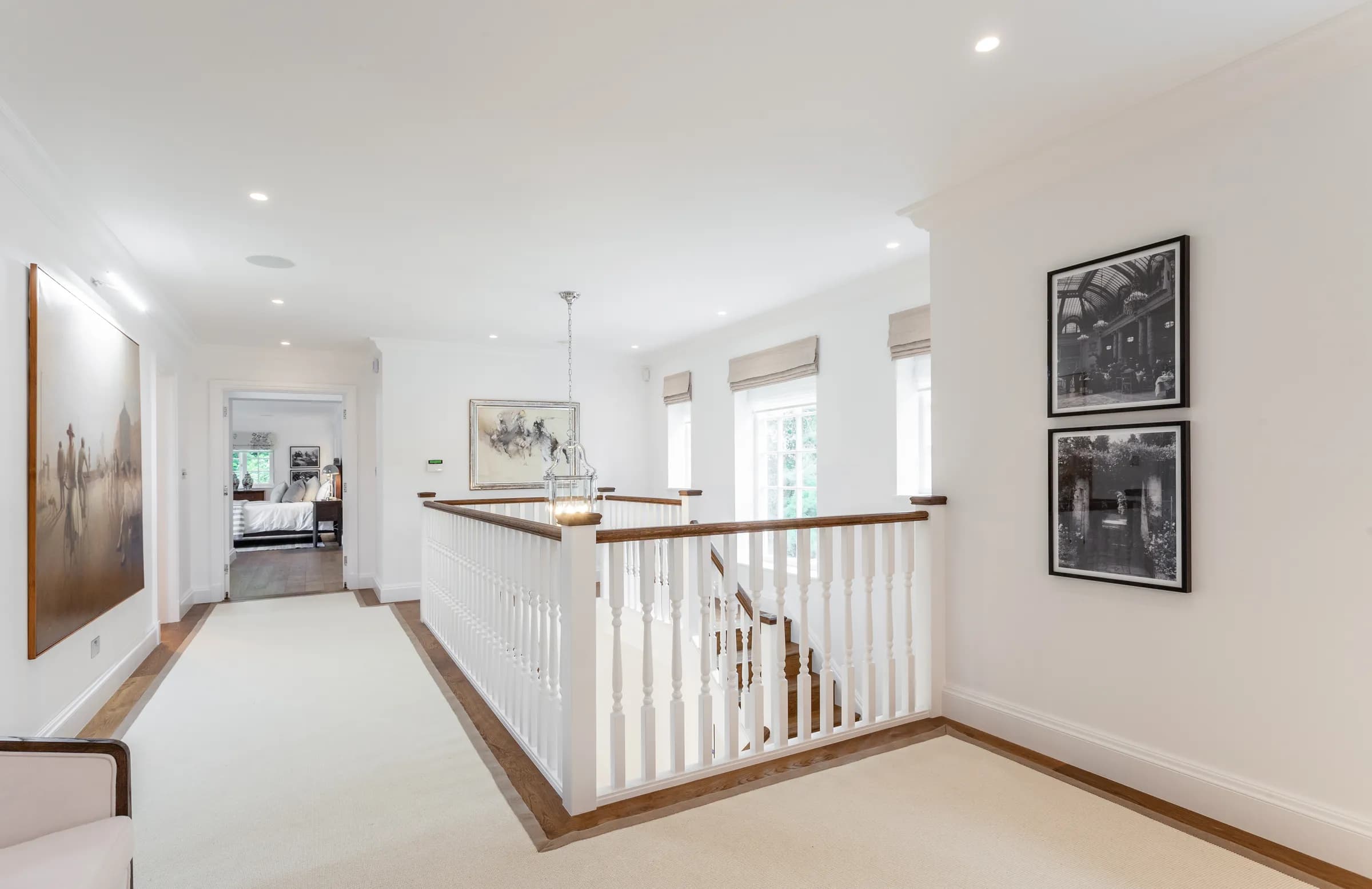 Upstairs landing with period banister detail and natural light flooding the stairwell